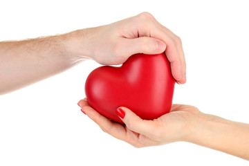 Obraz premium Red heart in woman and man hands, isolated on white