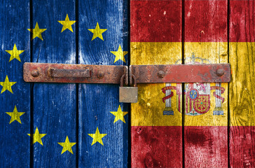 EU and Spain flag on the background of old locked doors
