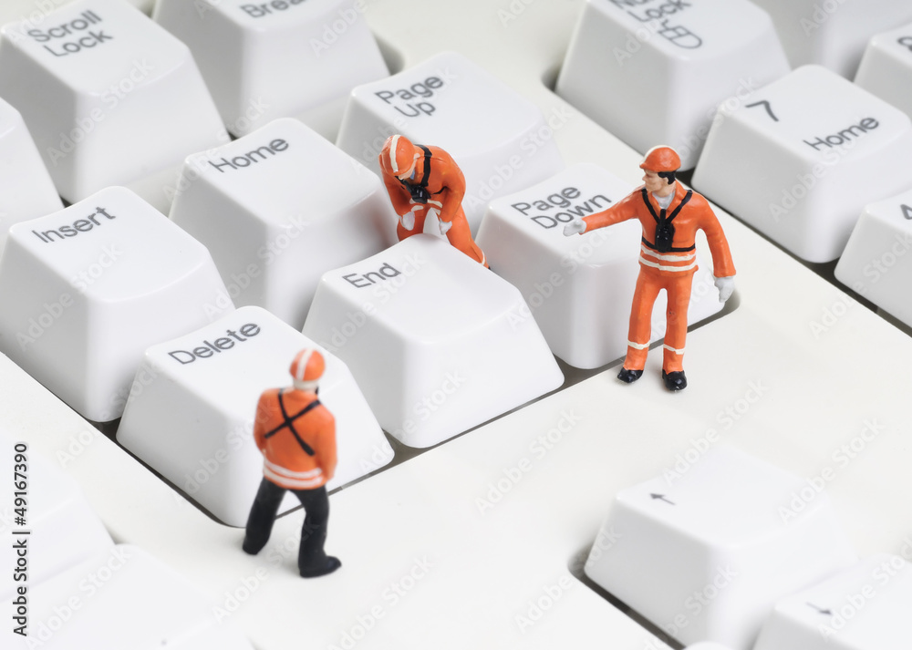 Wall mural tiny figures of construction engineers removing end key