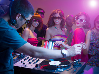 dj playing music with turntables   sunglasses  colorful lights