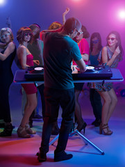 dj standing and mixing music at party