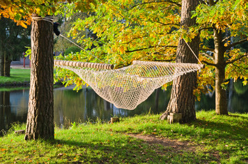 A hammock near the pond in autumn Park