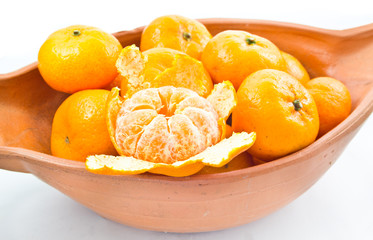 small orange in bowl isolated on white background