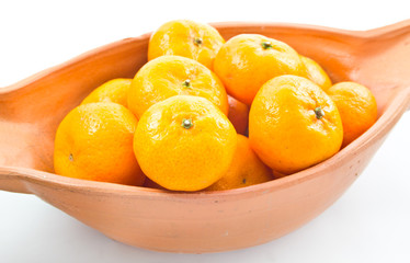 small orange in bowl isolated on white background