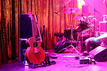 Guitar and other musical equipment on stage before concert