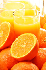 Composition with two glasses of orange juice and fruits