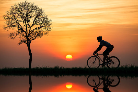Silhouette of a cyclist at sunset