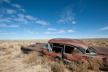 Old rusted car in the middle of New Mexico desert