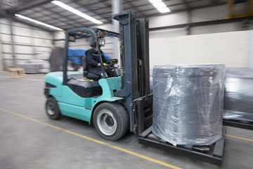 Forklift carrying cargo in factory
