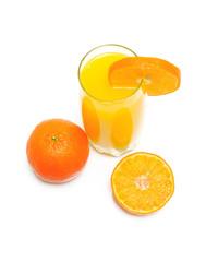 orange juice in a glass and oranges - top view