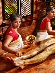 Woman having Ayurvedic feet spa massage. © Gennadiy Poznyakov