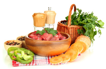 Raw beef meat in bowl with herbs and spices isolated on white