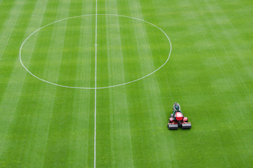 Mowing grass at the football stadium