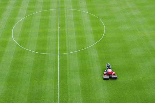 Mowing grass at the football stadium