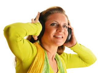 Happy young woman listening to the music in headphones isolated