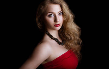 Portrait of Woman in red dress. attractive girl with curly hair