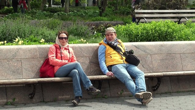 Girl & Guy are resting at the bench