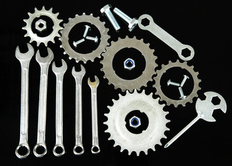 Machine gear, metal cogwheels, nuts and bolts isolated on black