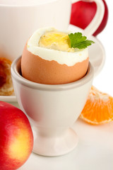 Light breakfast with boiled egg and cup of coffee, isolated