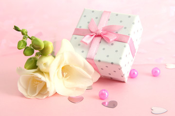 Beautiful romantic gift box and flower on pink background