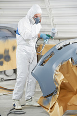 auto mechanic painting car bumper