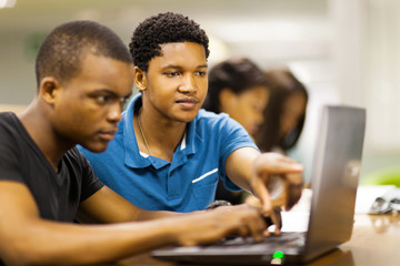 african college students using laptop together