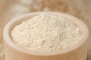 buckwheat flour in a wooden bowl horizontal closeup