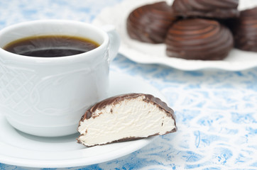 cup of black coffee and marshmallows in a cut in the chocolate