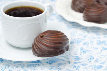 cup of black coffee and marshmallows in chocolate, closeup