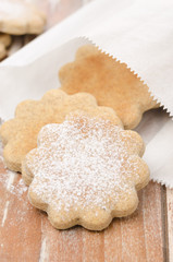 Fototapeta na wymiar figured cookies sprinkled with powdered sugar in a paper bag