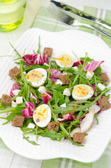 salad with quail eggs, feta and arugula, top view