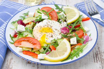Vegetable salad with poached egg on a plate, horizontal