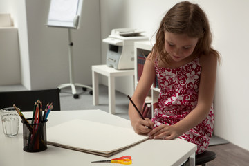 Cute little girl doing artwork