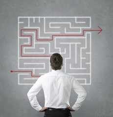 Confused businessman looking at the labyrinth