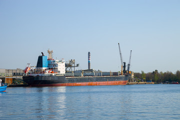 Naklejka premium Loading cargo ship in port Gdansk, Poland.