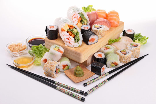 isolated sushi plank with assortment of sushi