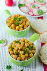 Boiled chickpeas in a green bowl