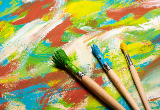 Paintbrushes on abstract grange background