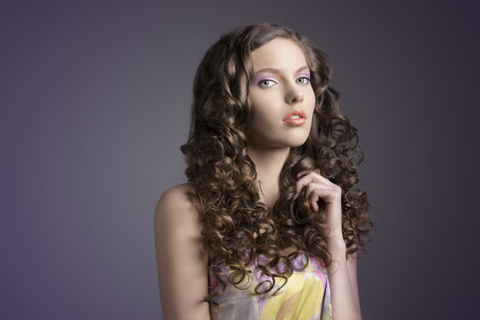pretty brunette with curly hairturned of three quarters