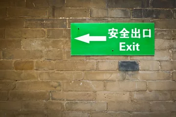 Foto op Canvas Bilingual exit sign © Mario Savoia