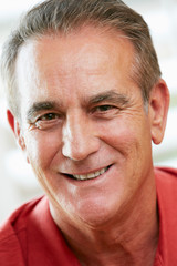 Portrait Of Happy Senior Man At Home