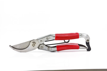 Red garden secateurs isolated on a white background