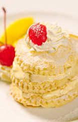 Dessert cake topping with cream and cherry