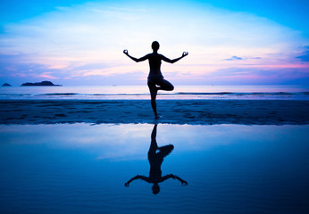 Silhouette of a beautiful yoga woman in the morning