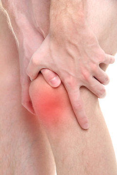 Man holding sore knee, isolated on white