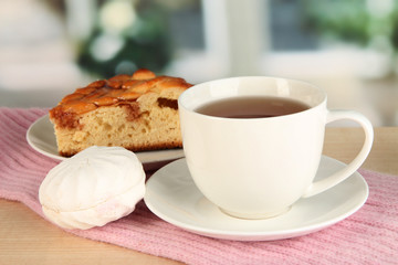 cup of tea with scarf on table in room