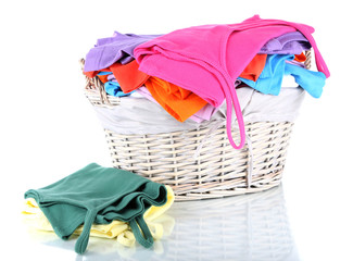 Clothes in wooden basket isolated on white