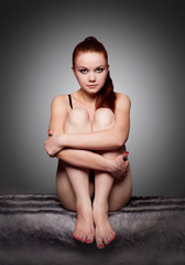 woman sit on a fur in studio