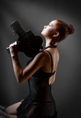 woman with old camera in studio