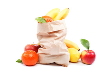 Fresh fruits in a paper bag isolated on a white background.